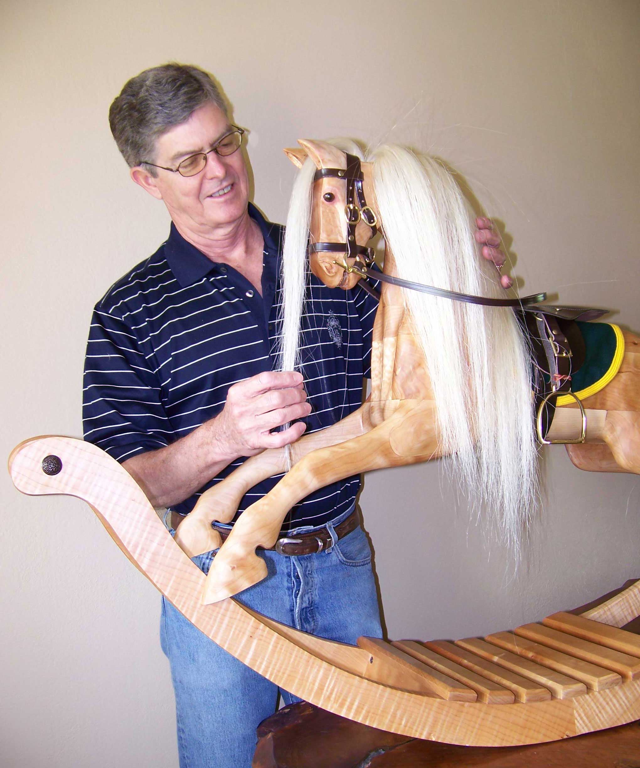 Al Carr with one of his heirloom wooden rocking horses.